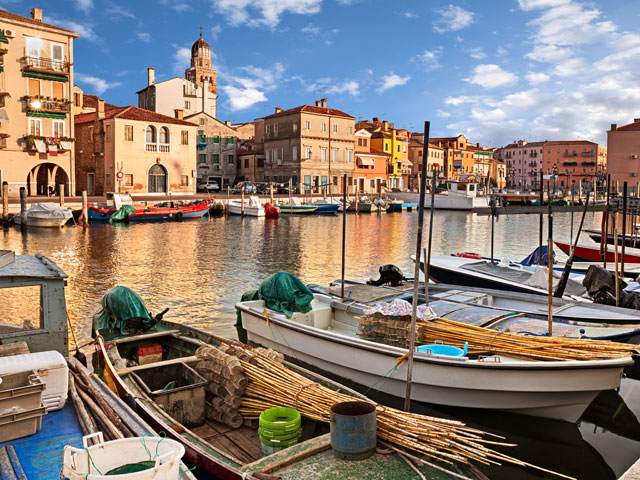 River boats and waterfront buildings in Chiogga, Italy