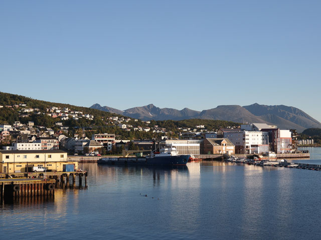 Buildings by the water with mountains in background, Harstad