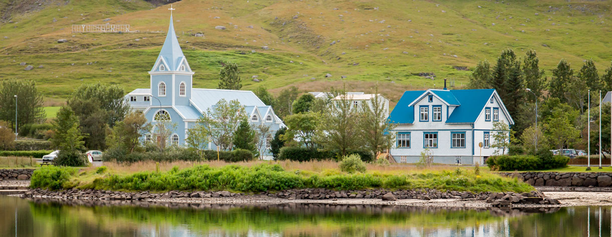 Homes and church at enchanting fjord of Seydisfjordur