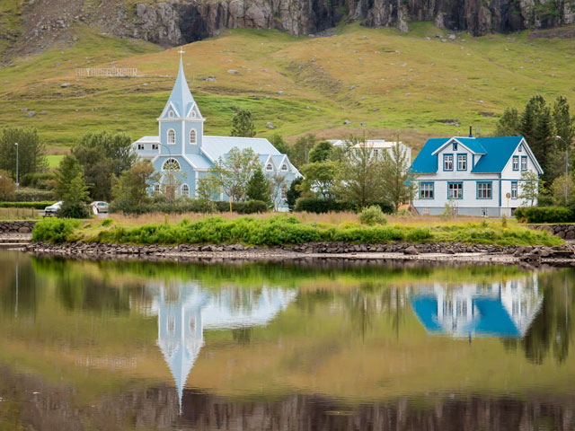 Homes and church at enchanting fjord of Seydisfjordur