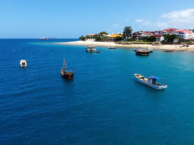 The island of Zanzibar Stone Town city and the Indian ocean aerial view