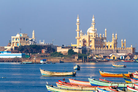 Fishing harbour with mosque in the background in the background at dawn