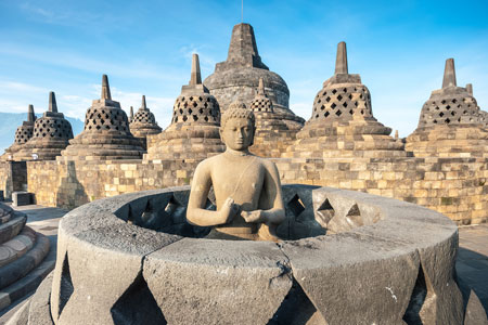 Ancient Buddha statue and stupa at Borobubur temple, Indonesia