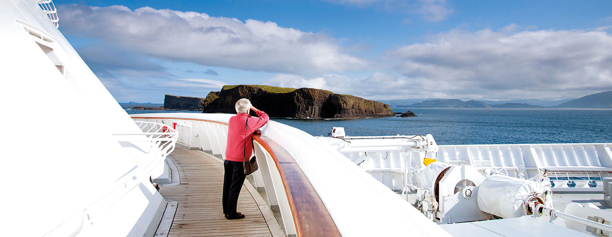 Lady looking out to Fingals Cave from deck
