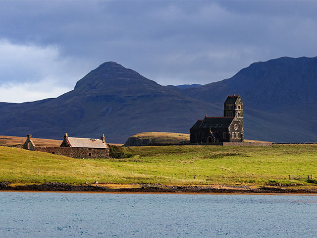 The old church on the isle of Canna in the Hebrides in Scotland with dramatic clouds