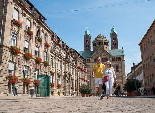 Couple walking away from Speyer Cathedral, Germany Iconic Landmarks of the Rhine & Moselle