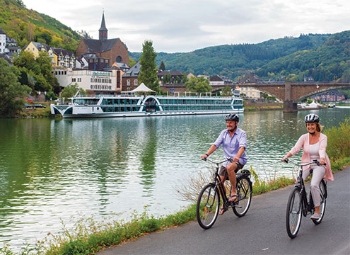 Couple cycling in Cochem, Germany with Brabant in the background Tipples & Treasures of the Rhine and Moselle