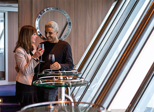 Couple having drinks in the Observatory Cruise to Nowhere