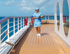 Waitress walking on deck with a tray of drinks