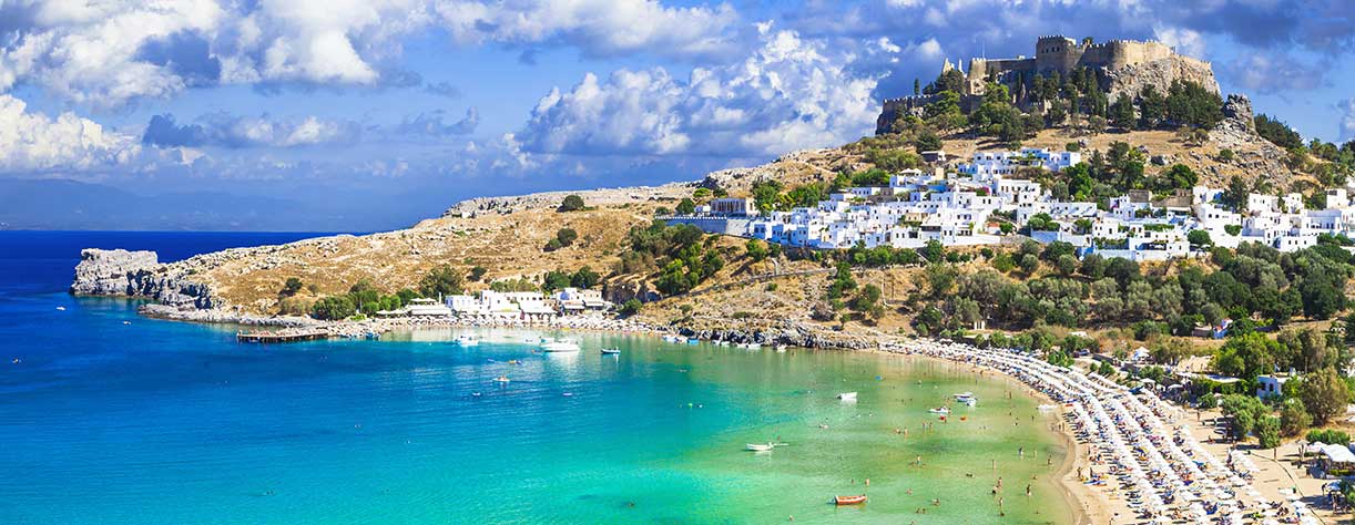 Panoramic view of Lindos bay, village and Acropolis, Rhodes, Greece