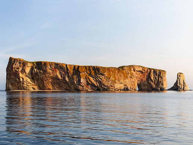 Perce Rock view with reflections at Gaspe Peninsula coast in Quebec, Canada.