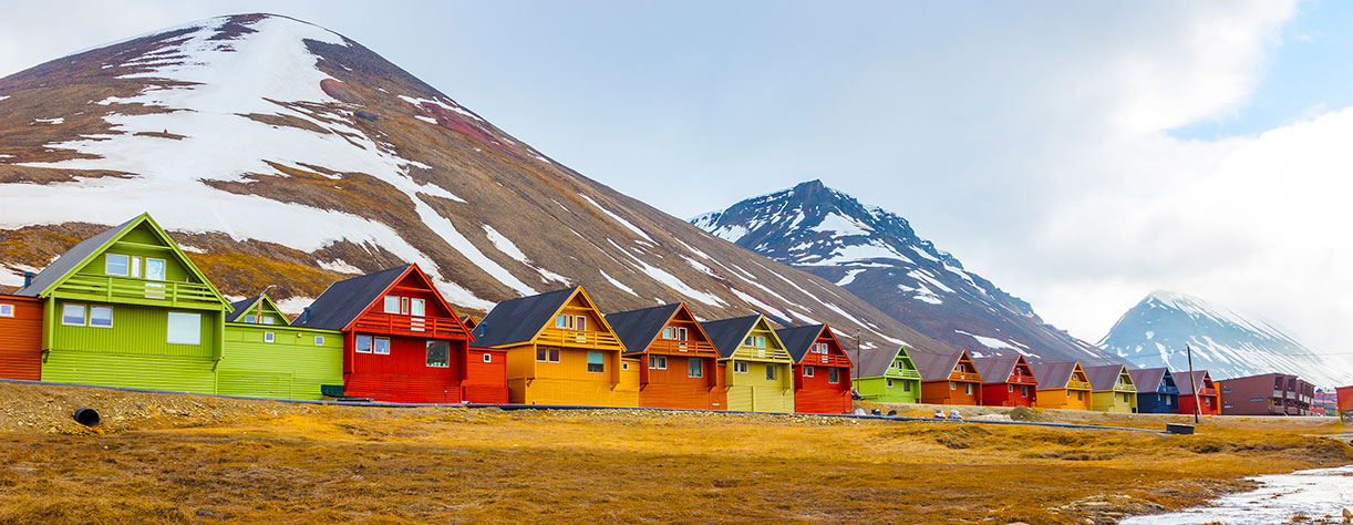 Colourful houses with snowy mountains in the background, Longyearbyen, Spitsbergen