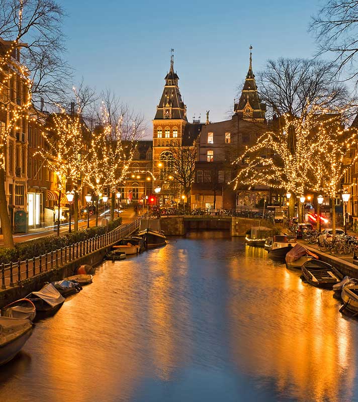 Christmas time in Amsterdam with the Rijksmuseum in Netherlands at twilight Christmas time in Amsterdam with the Rijksmuseum in Netherlands at twilight