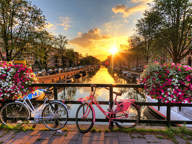 Bicycles over bridge of canal, Amsterdam, Netherlands