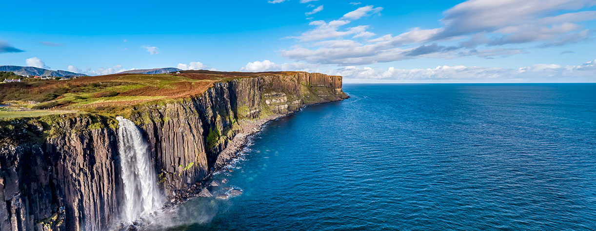 Aerial view of the dramatic coastline at the cliffs by Staffin with the famous Kilt Rock waterfall , Scotland