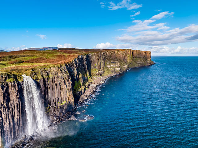 Aerial view of the dramatic coastline at the cliffs by Staffin with the famous Kilt Rock waterfall , Scotland