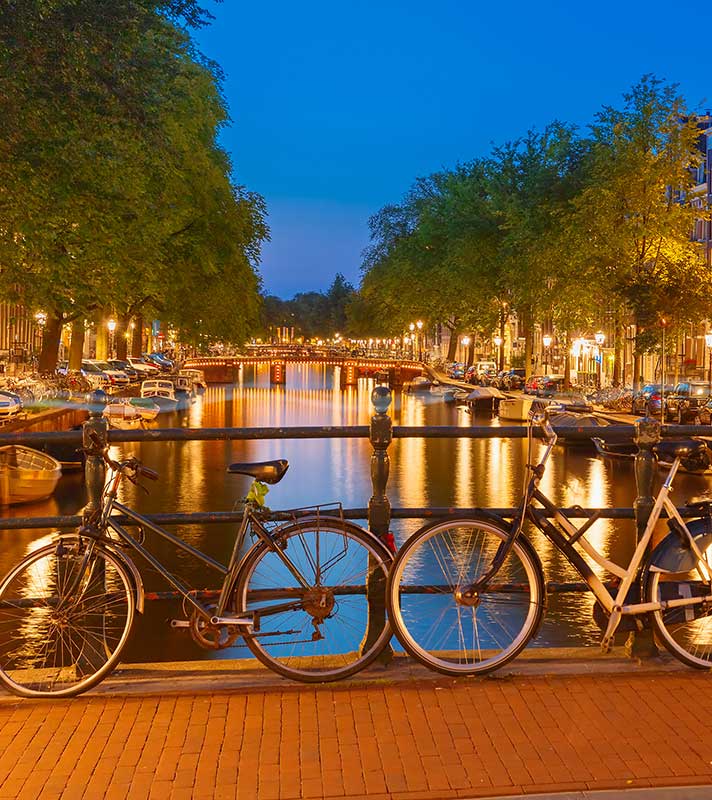 Night city view of Amsterdam canal, bridge, boats and bicycles, Holland, Netherlands. Night city view of Amsterdam canal, bridge, boats and bicycles, Holland, Netherlands.