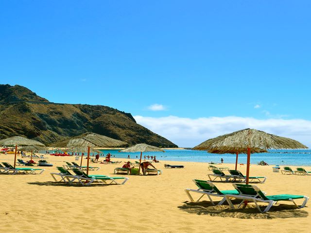 Las Teresitas with yellow sand, umbrellas, loungers and palm trees, Santa Cruz, Tenerife