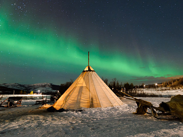 Traditional Sami reindeer-skin tents, The northern lights in Norway, Tromso 