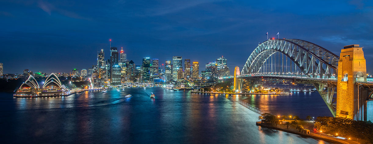 Cityscape image of Sydney, Australia with Harbour Bridge and Sydney skyline during sunset