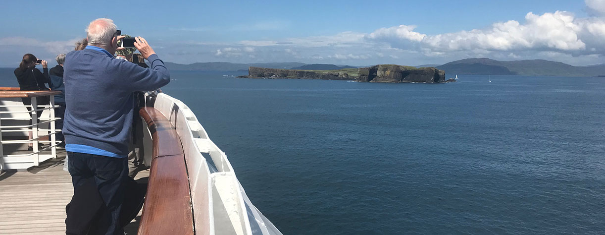 Guests looking out to Fingal's cave from on board, UK