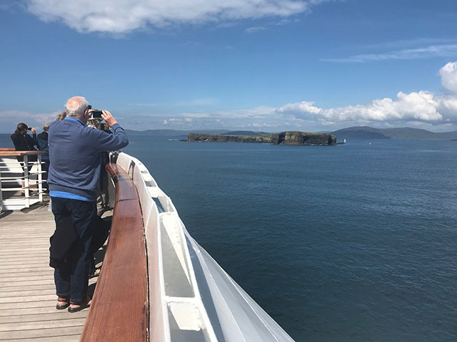 Guests looking out to Fingal's cave from on board, UK