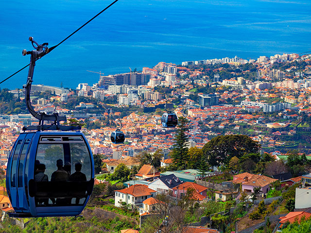 Aerial view of Funchal with traditional cable car above the city, in Madeira island, Portugal