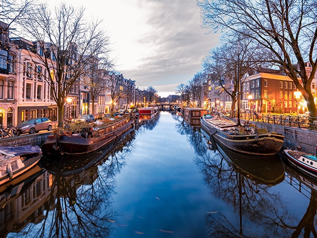 Amsterdam canals in the evening light, Dutch canals in Amsterdam Holland Netherlands during winter time