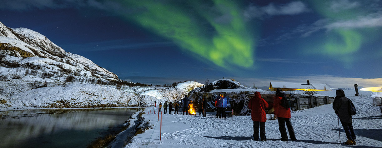 Guests watching the Northern Lights over Tromso, Norway
