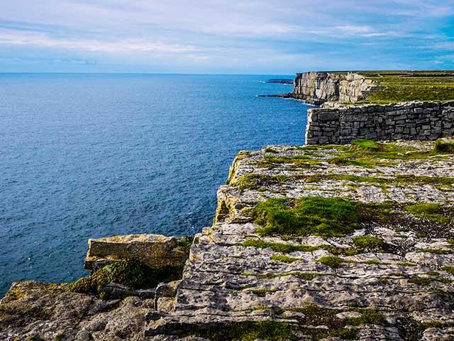 Beautiful view of the Inis Mór cliffs on a cloudy day