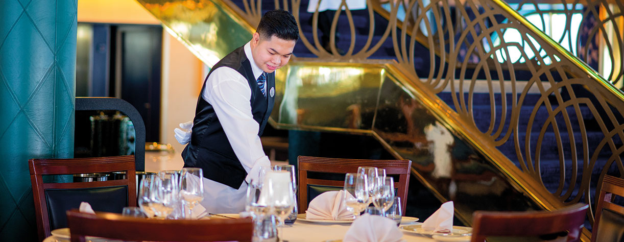 Waiter setting the table in The Bloomsbury Restaurant, Bolette