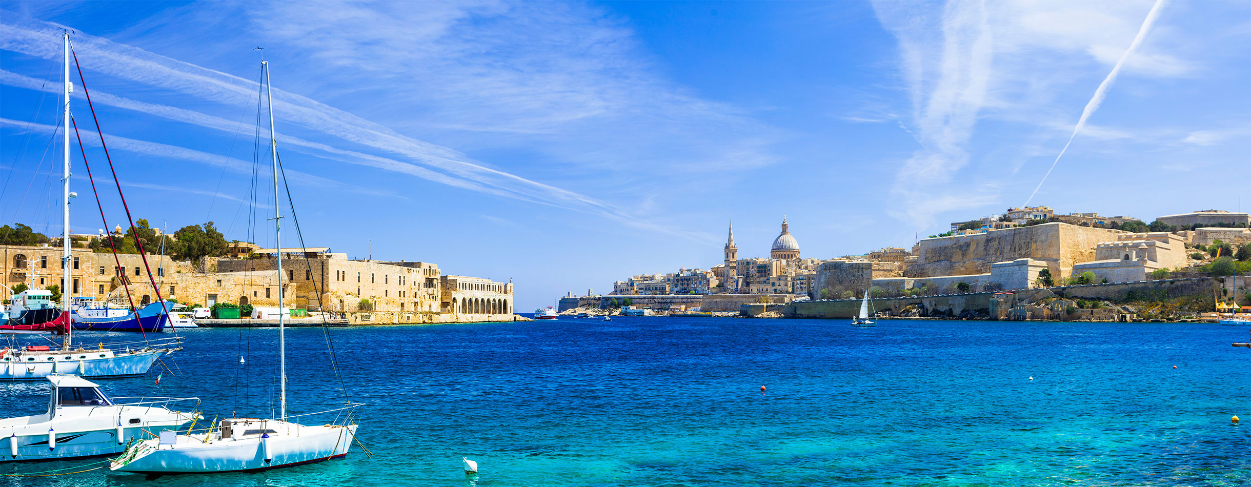 Panoramic view of Valetta with sailing boats in turquoise sea. Malta