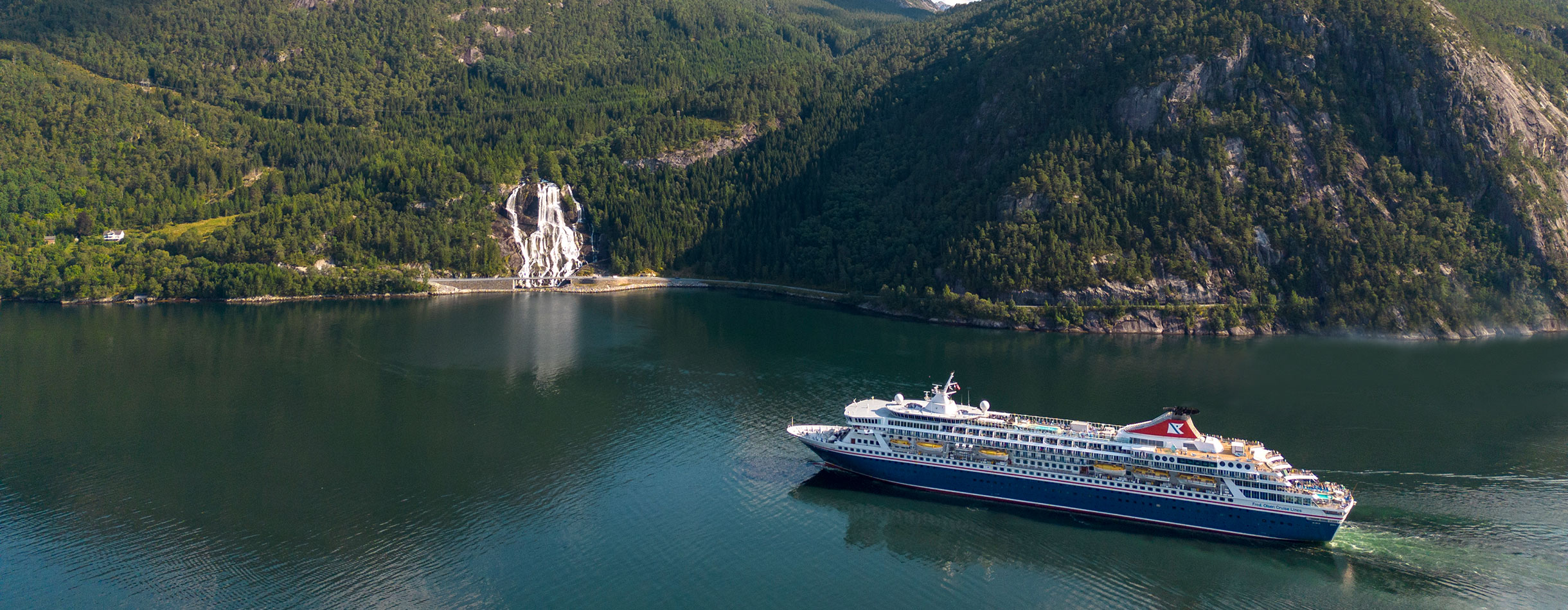 Balmoral cruising by Furebergsfossen waterfall, Norway