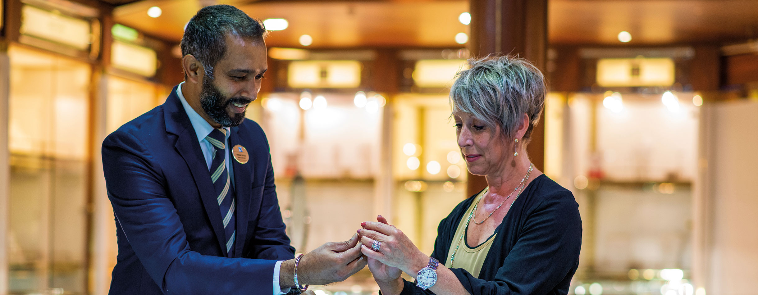 Guests looking at jewellry with member of staff