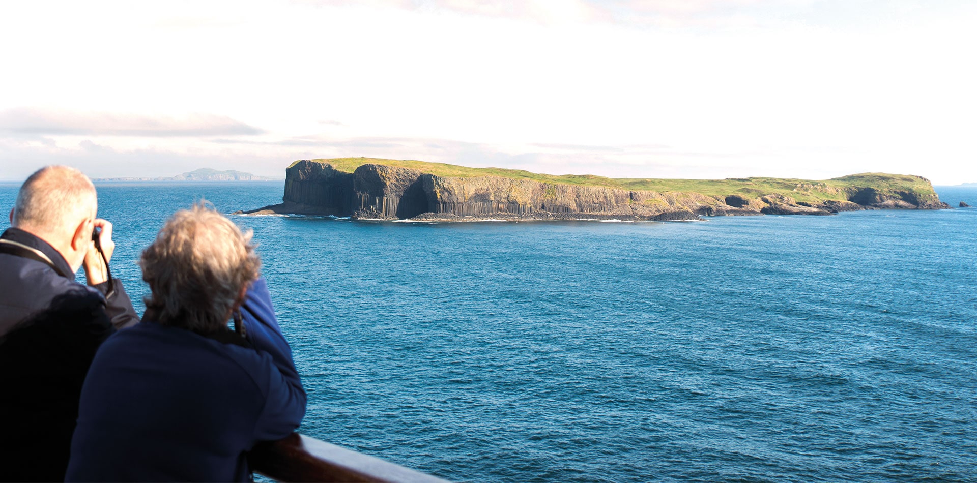 Guests looking out to Fingal's cave from deck
