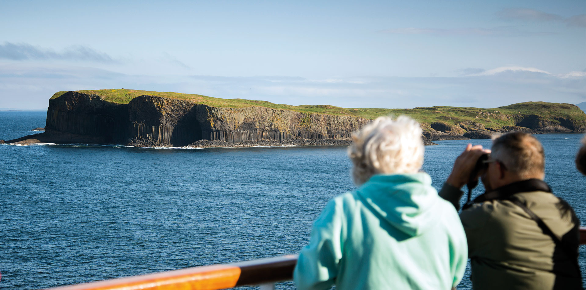 Guests looking out from deck to Fingal's cave, Scotland