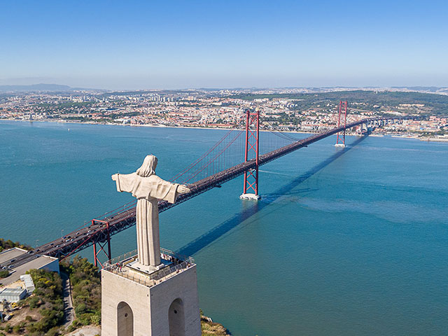 View of the 25 de Abril Bridge and a statue of Jesus Christ, Lisbon, Portugal