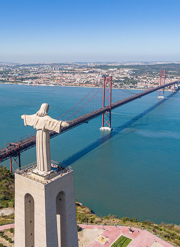 View of the 25 de Abril Bridge and a statue of Jesus Christ, Lisbon, Portugal