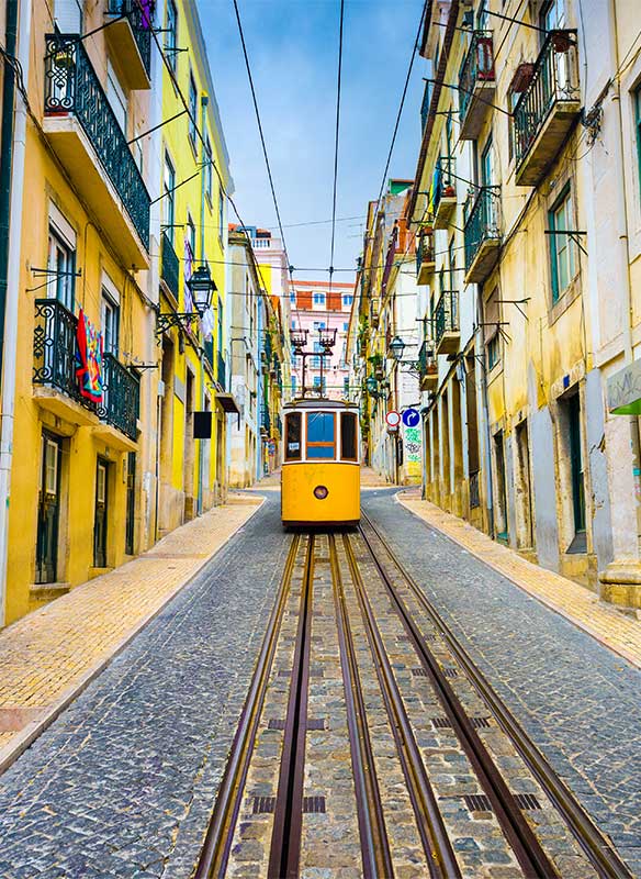 Lisbon, Portugal old town streets and tram.