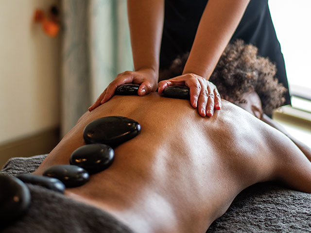 Guests enjoying a hot stone massage 