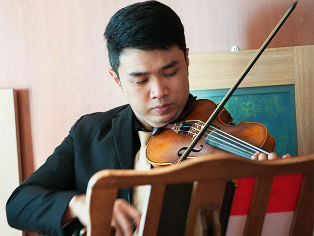 Violinist performing on board 