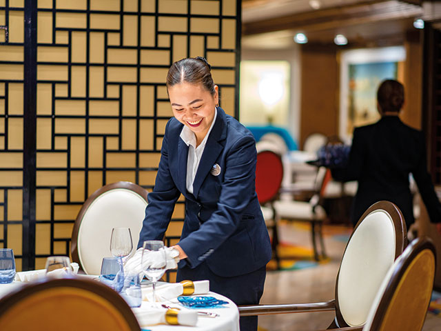 Waitress dressing the table in Colours & Tastes