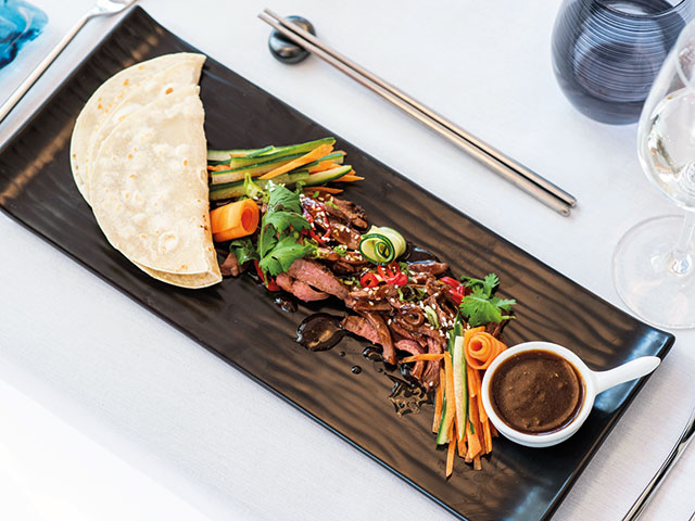 A beautifully presented dish from the Colours & Tastes restaurant, featuring vibrant and fresh ingredients.