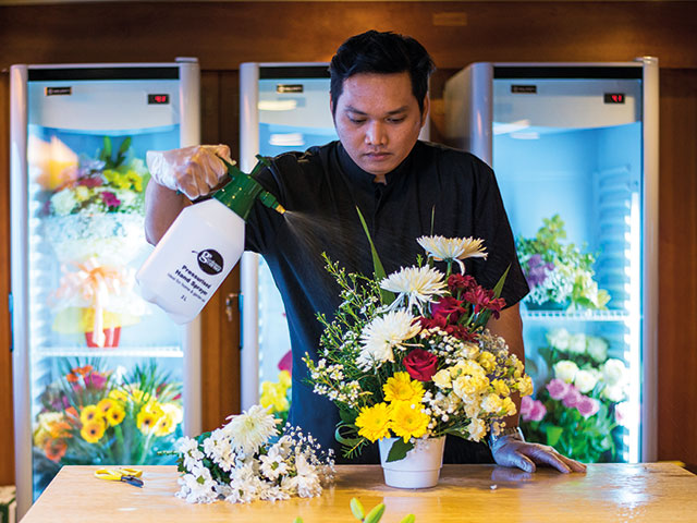 Team member arranging flowers 