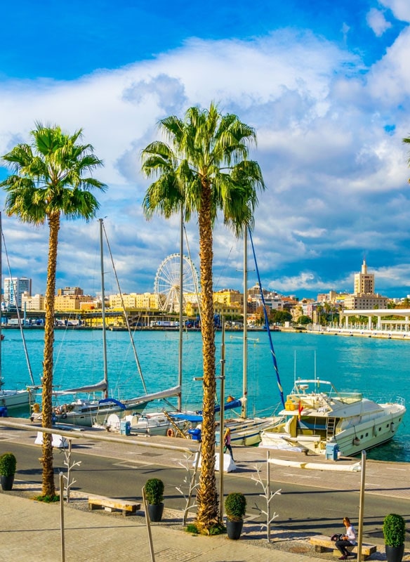 Promenade surrounded by marina in the port of Malaga, Spain Promenade surrounded by marina in the port of Malaga, Spain