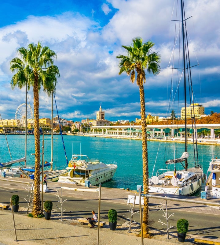 Promenade surrounded by marina in the port of Malaga, Spain Promenade surrounded by marina in the port of Malaga, Spain