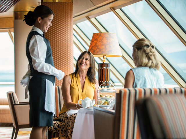 A waitress serving traditional afternoon tea in The Observatory on Borealis