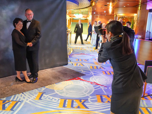 Onboard photographer taking picture of guests on formal night