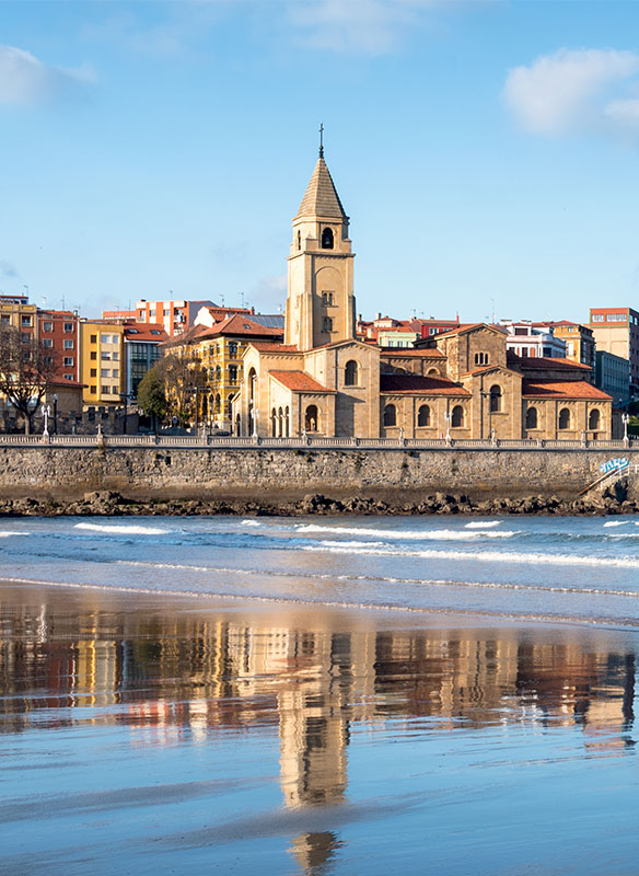Gijon cliff and San Pedro church, reflection in San Lorenzo beach, Asturias. Gijon cliff and San Pedro church, reflection in San Lorenzo beach, Asturias.