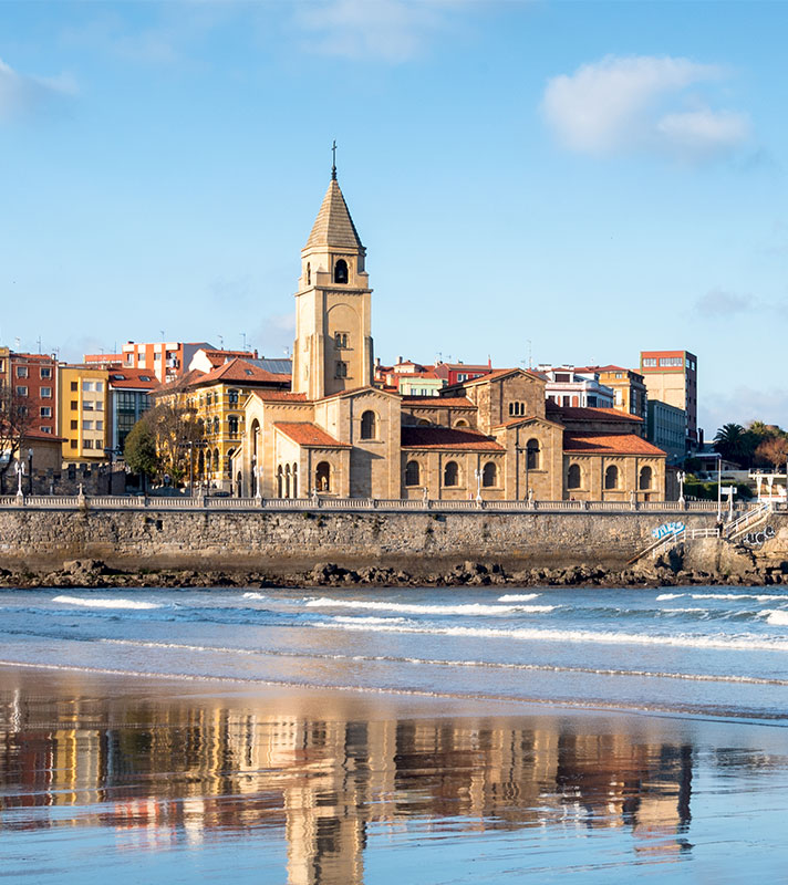 Gijon cliff and San Pedro church, reflection in San Lorenzo beach, Asturias. Gijon cliff and San Pedro church, reflection in San Lorenzo beach, Asturias.